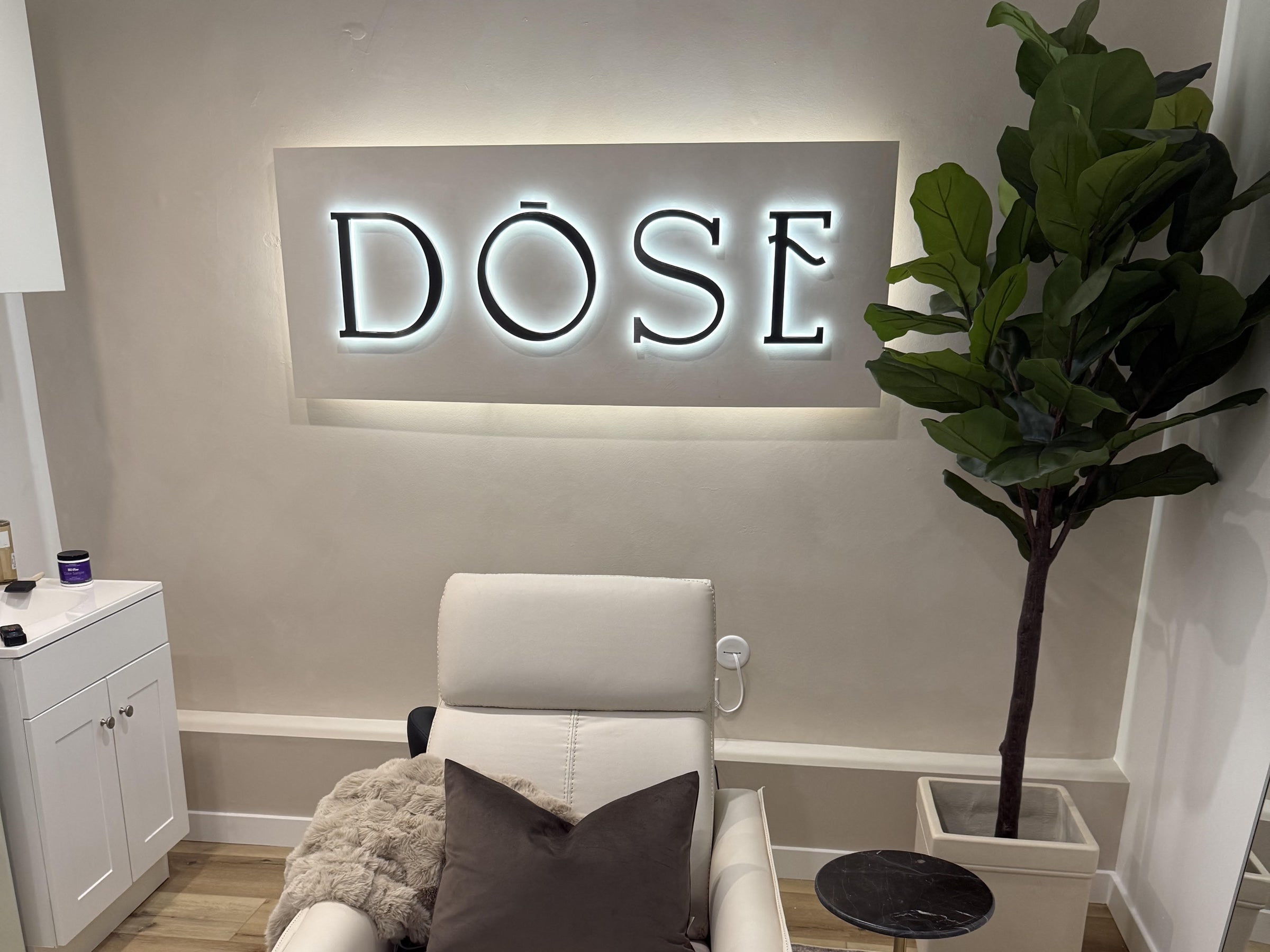 Customer-installed DOSE dimensional logo with halo lighting on a backboard